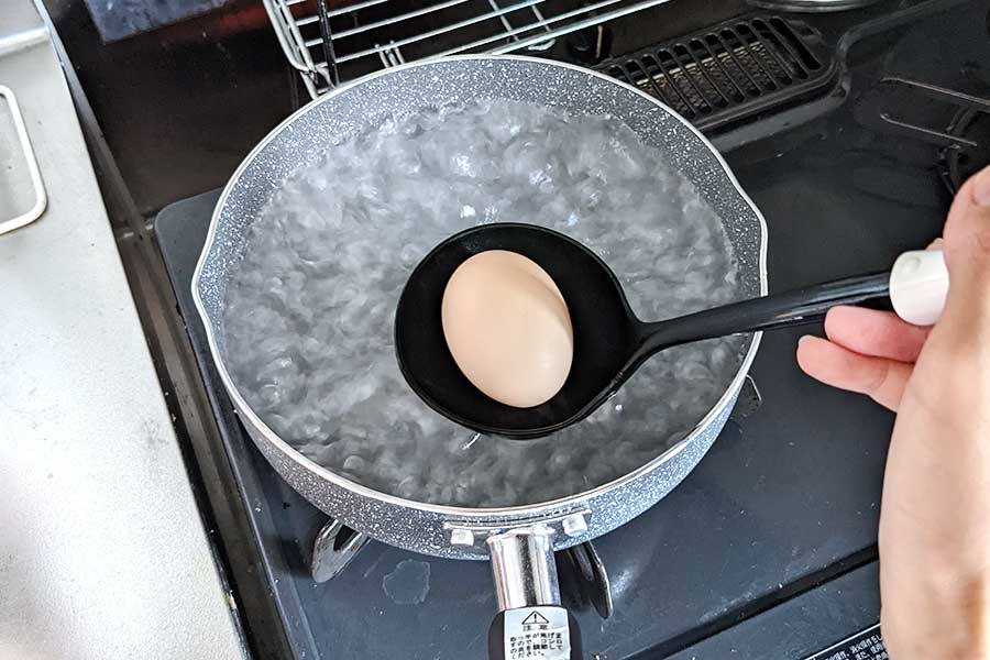卵を入れる際は、割れないようにおたまでお湯の中へ【写真：Hint-Pot編集部】